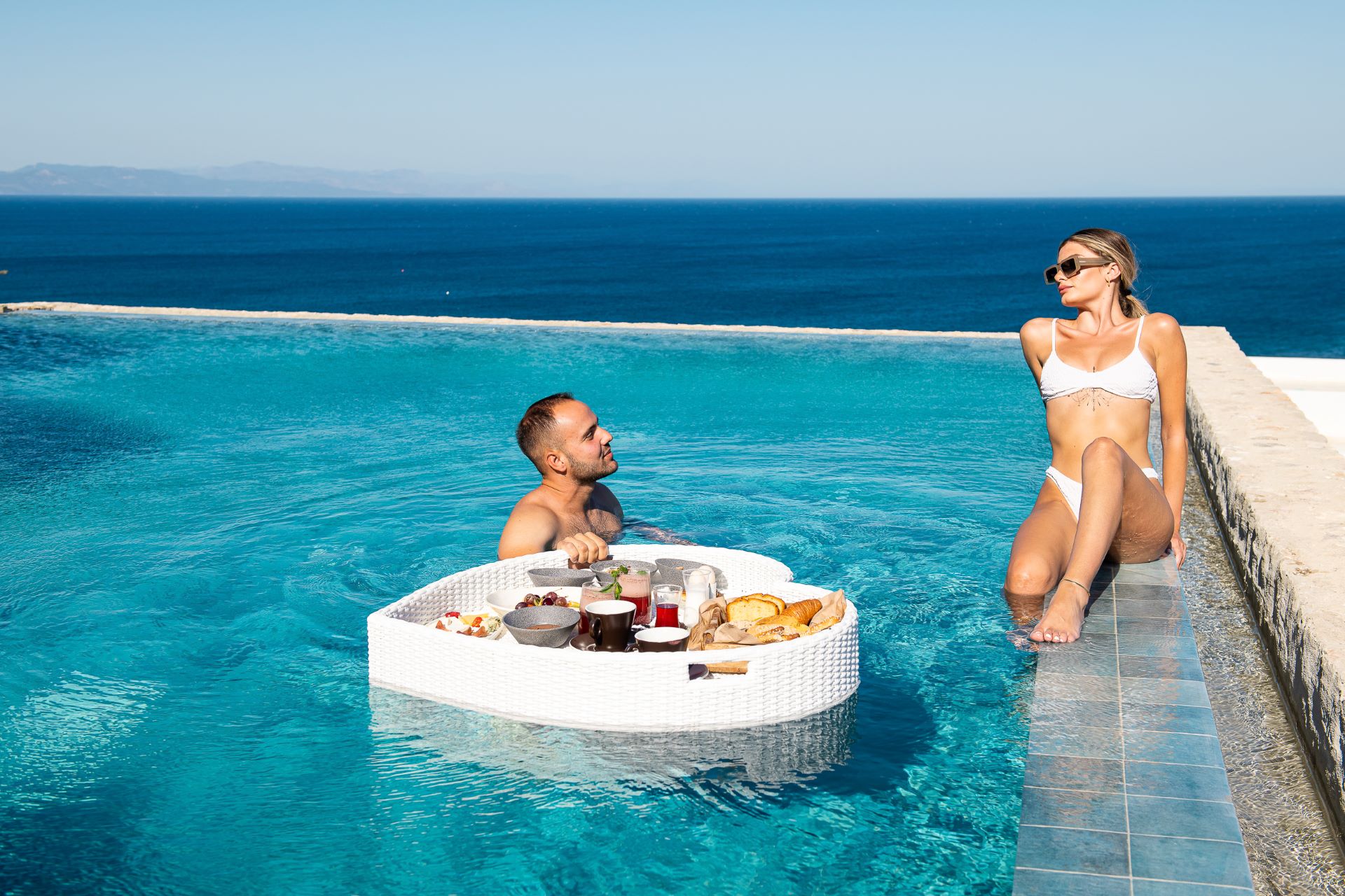 Starting the day with a floating breakfast in a heart-shaped tray is one of the most romantic things to do in Kos, at KOIA Resort.